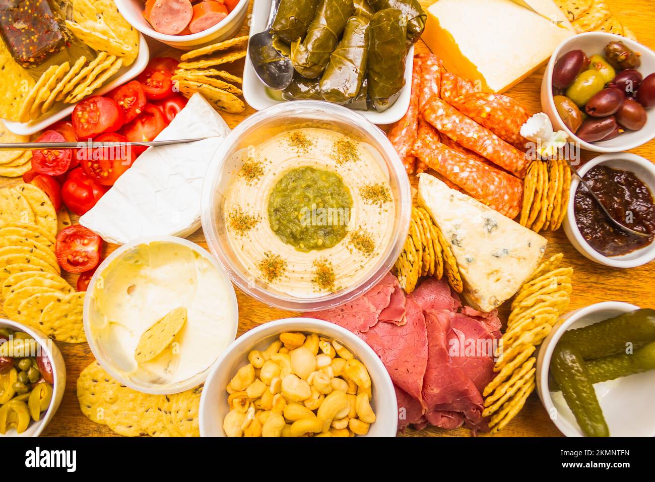 Food photograph on a mixed up appetiser of cheeses, dips, meats and ...