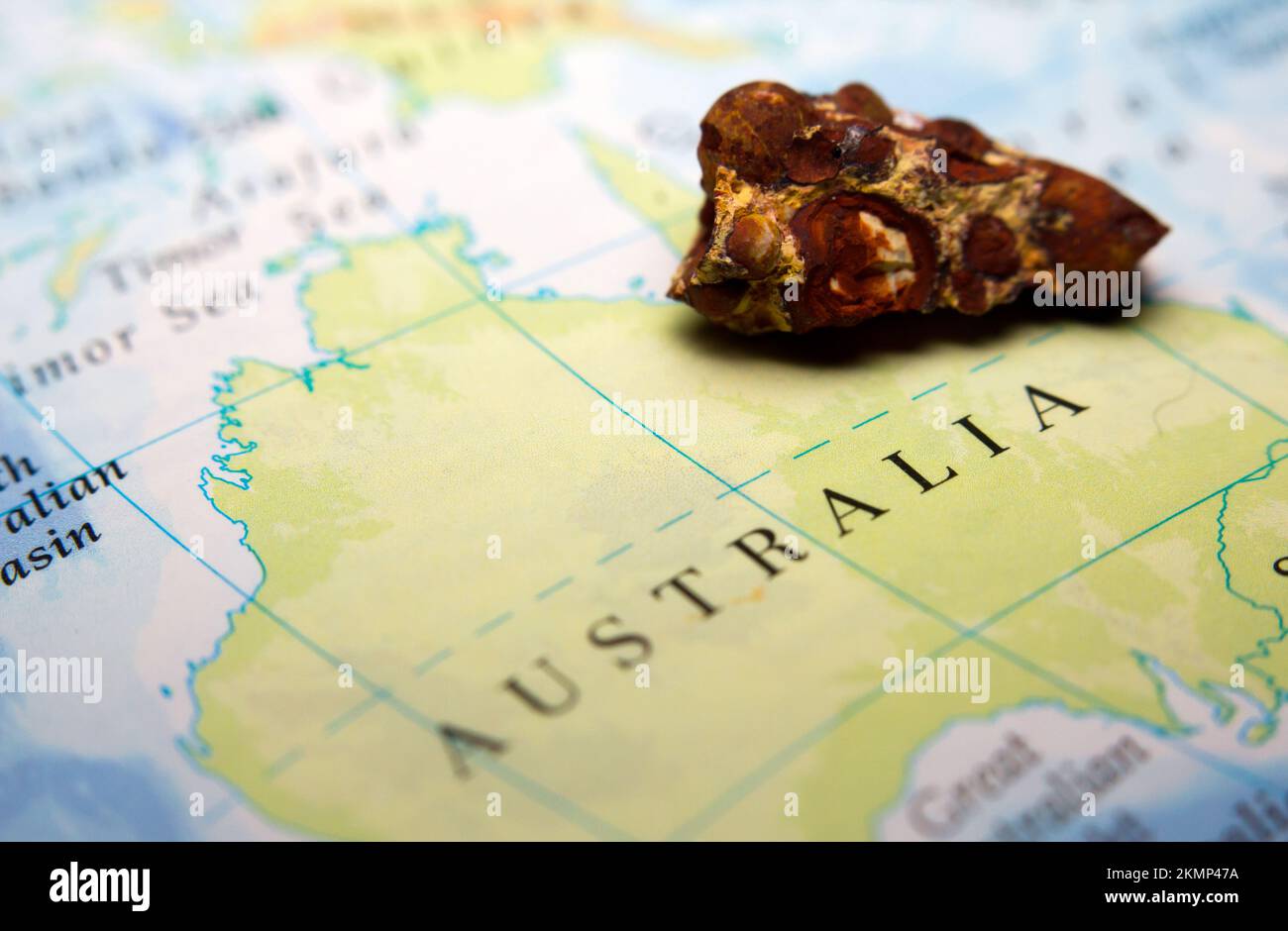 Closeup of Bauxite mineral or aluminium ore on top of a map of