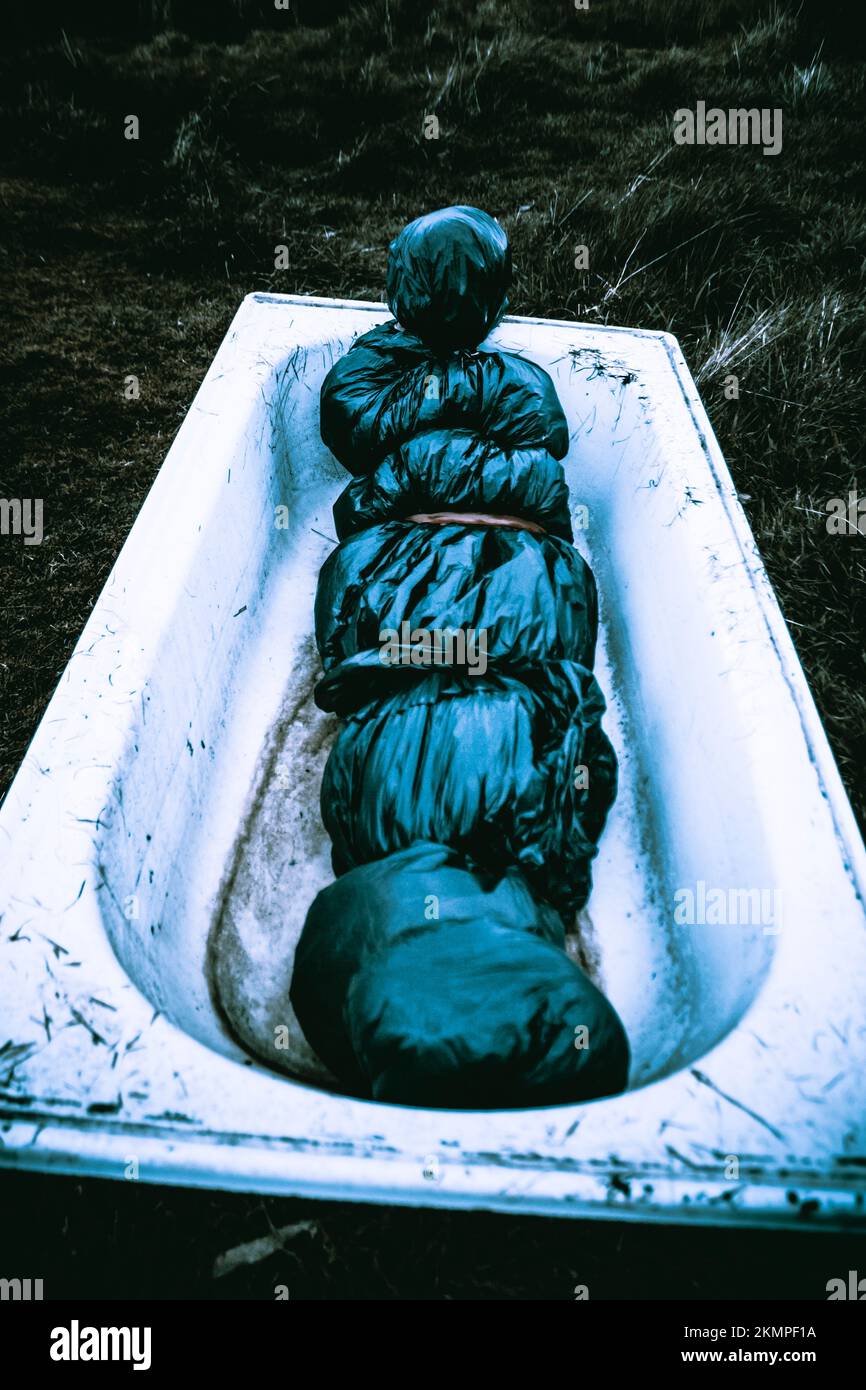 Chilling nightmare scene of a dumped bodybag laying in a countryside