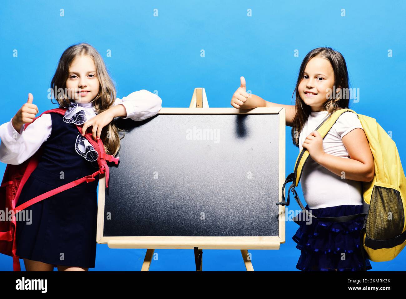 Girls with smiling faces and thumbs up. Back to school Stock Photo - Alamy