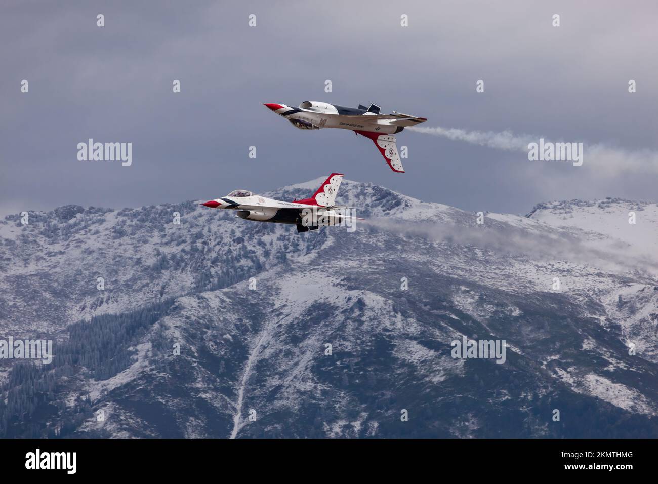 A pair of US Air Force Thunderbirds in tight formation with the snow-capped Wasatch Range in the background, Hill Air Force Base, Utah Stock Photo
