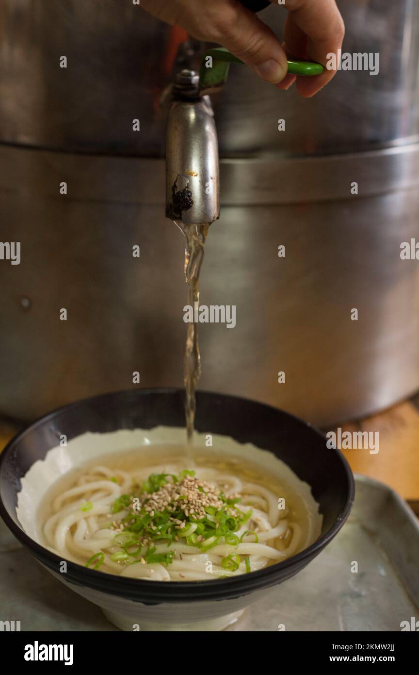 Hot dashi broth is atmospherically selfserve at Hyogo Udon Stock Photo Alamy