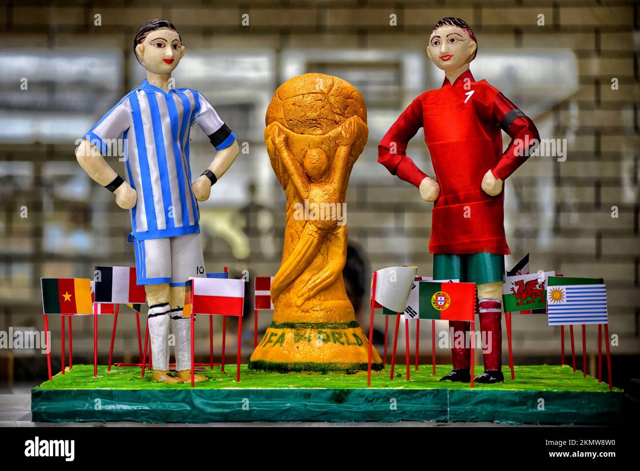 Kolkata, India. 26th Nov, 2022. A replica of the FIFA World Cup 2022 trophy with Lionel Messi and Cristiano Ronaldo made from sweets at a confectionery shop (Balaram Mallick) in Kolkata. Credit: SOPA Images Limited/Alamy Live News Stock Photo