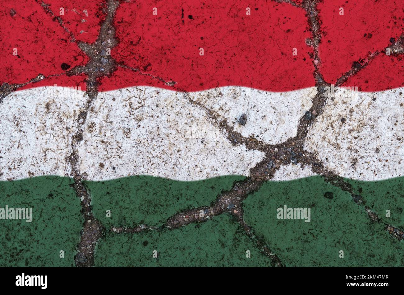 Hungary flag on cracked asphalt. The concept of crisis, default, economic collapse, pandemic, conflict, terrorism in the country. Out of focus image Stock Photo