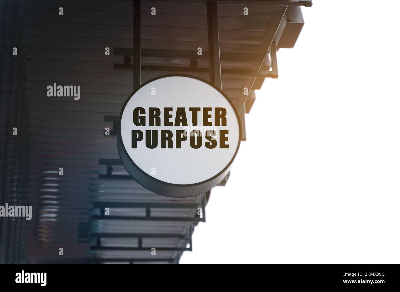 Business and Economics. There is a circular sign under the roof of the building that says - Greater Purpose Stock Photo