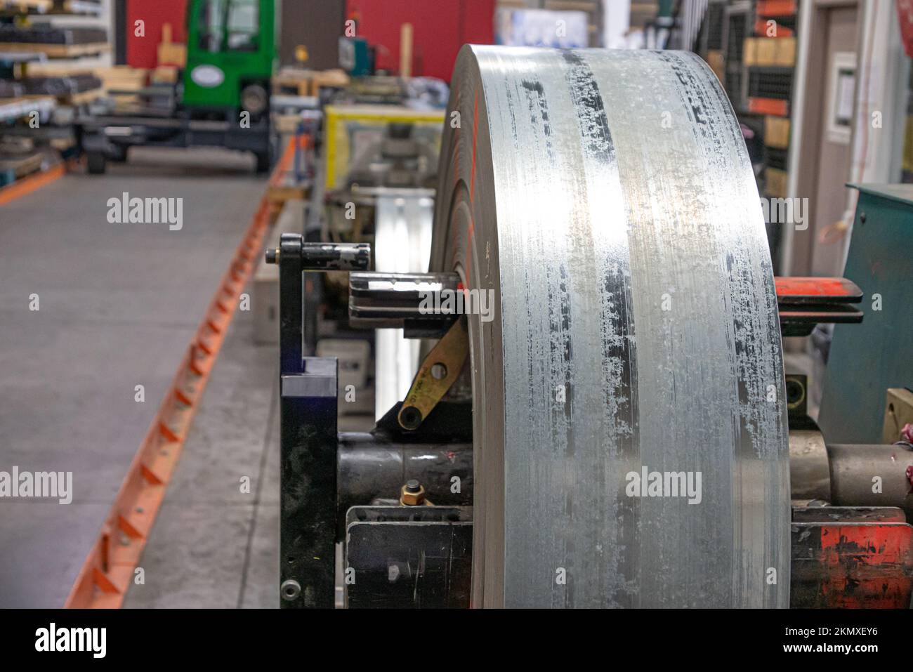 roll of silver metal steel coil in a roofing factory Stock Photo