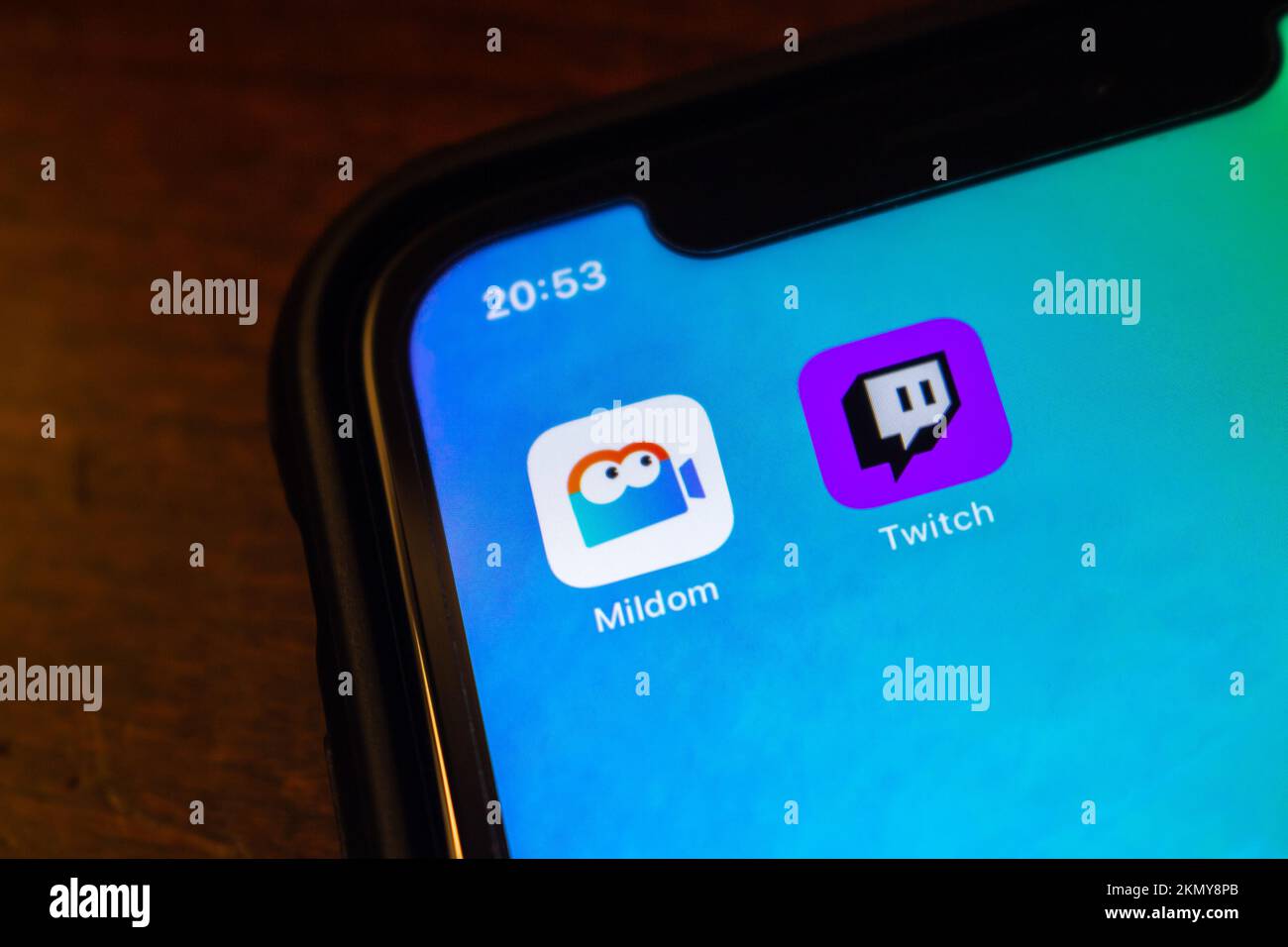 Vancouver, CANADA - Oct 17 2022 : Mildom and Twitch app icons on an iPhone screen. E-sports live streaming platform competition concept Stock Photo