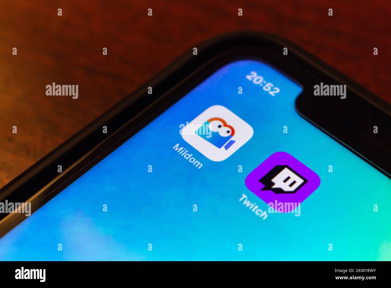 Vancouver, CANADA - Oct 17 2022 : Mildom and Twitch app icons on an iPhone screen. E-sports live streaming platform competition concept Stock Photo