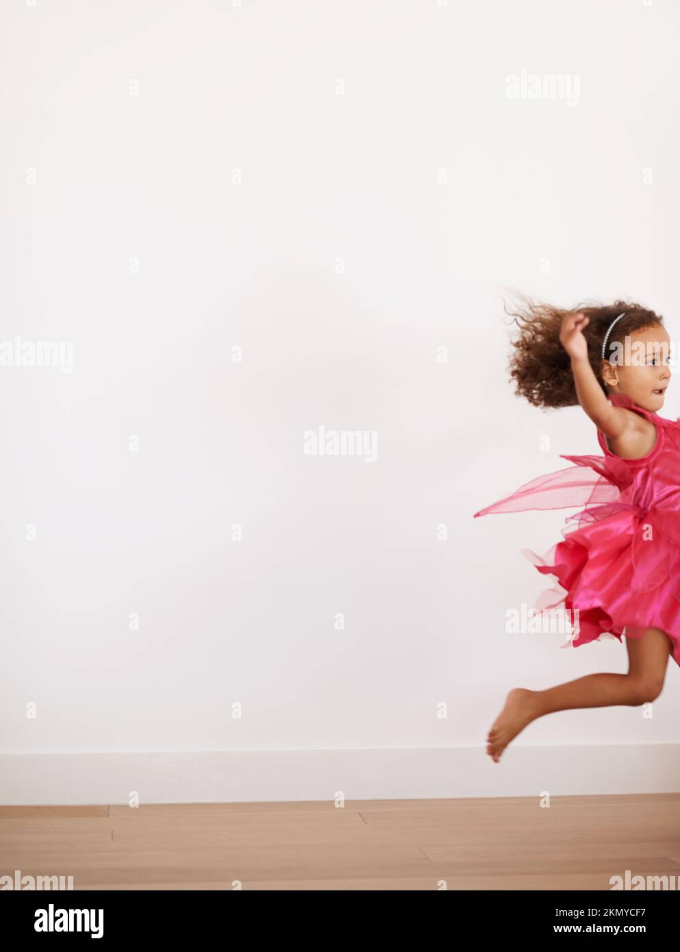 Sugar rush. an exuberant little girl running indoors. Stock Photo
