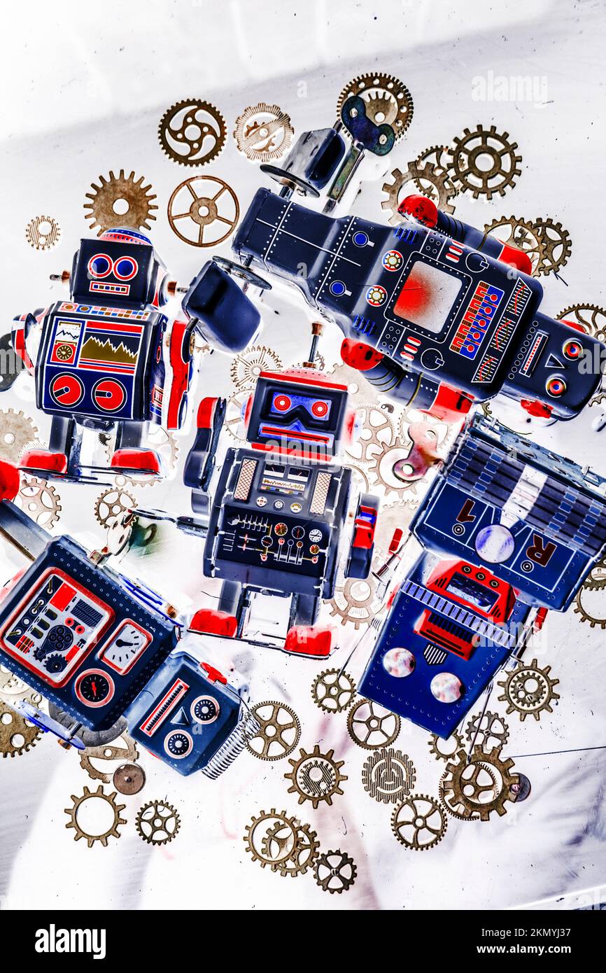 Creative still life artwork on a mix of classic robot toys in mechanical creation. Tin toy factory Stock Photo