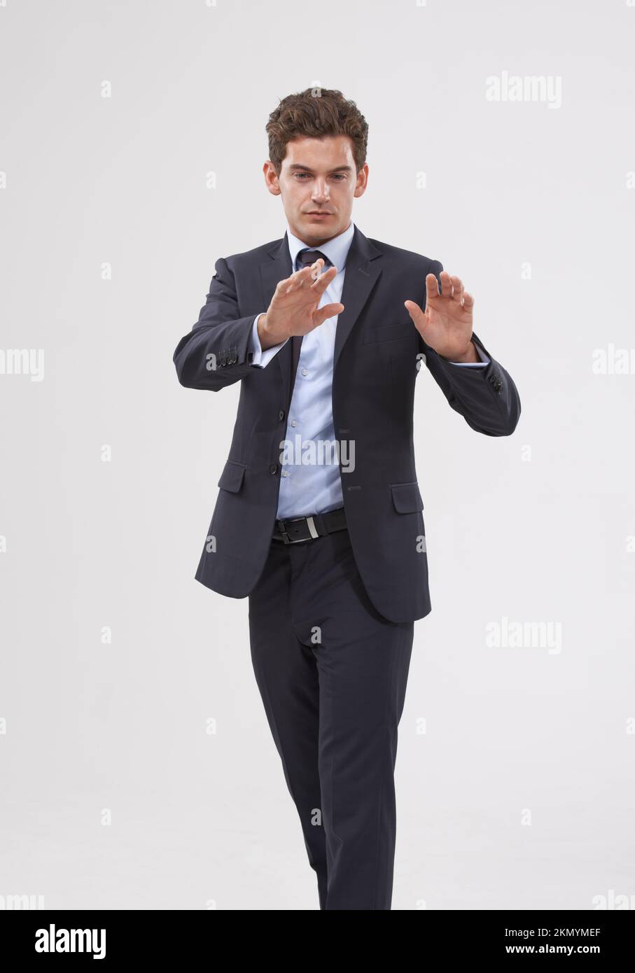 Moving toward the future. Businessman holding up his hand in a stop sign. Stock Photo