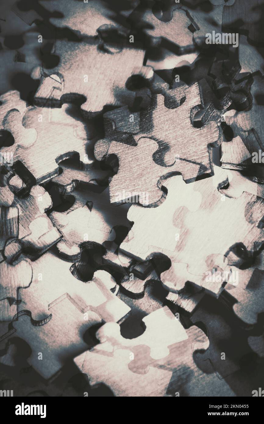 Incomplete disorganised art on a mix of game pieces in puzzling form. Jigsaws of double exposure Stock Photo