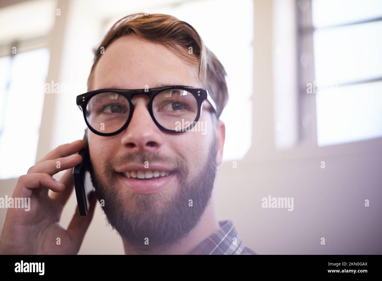 Being handsome is just part of the package. a handsome young hipster wearing glasses. Stock Photo