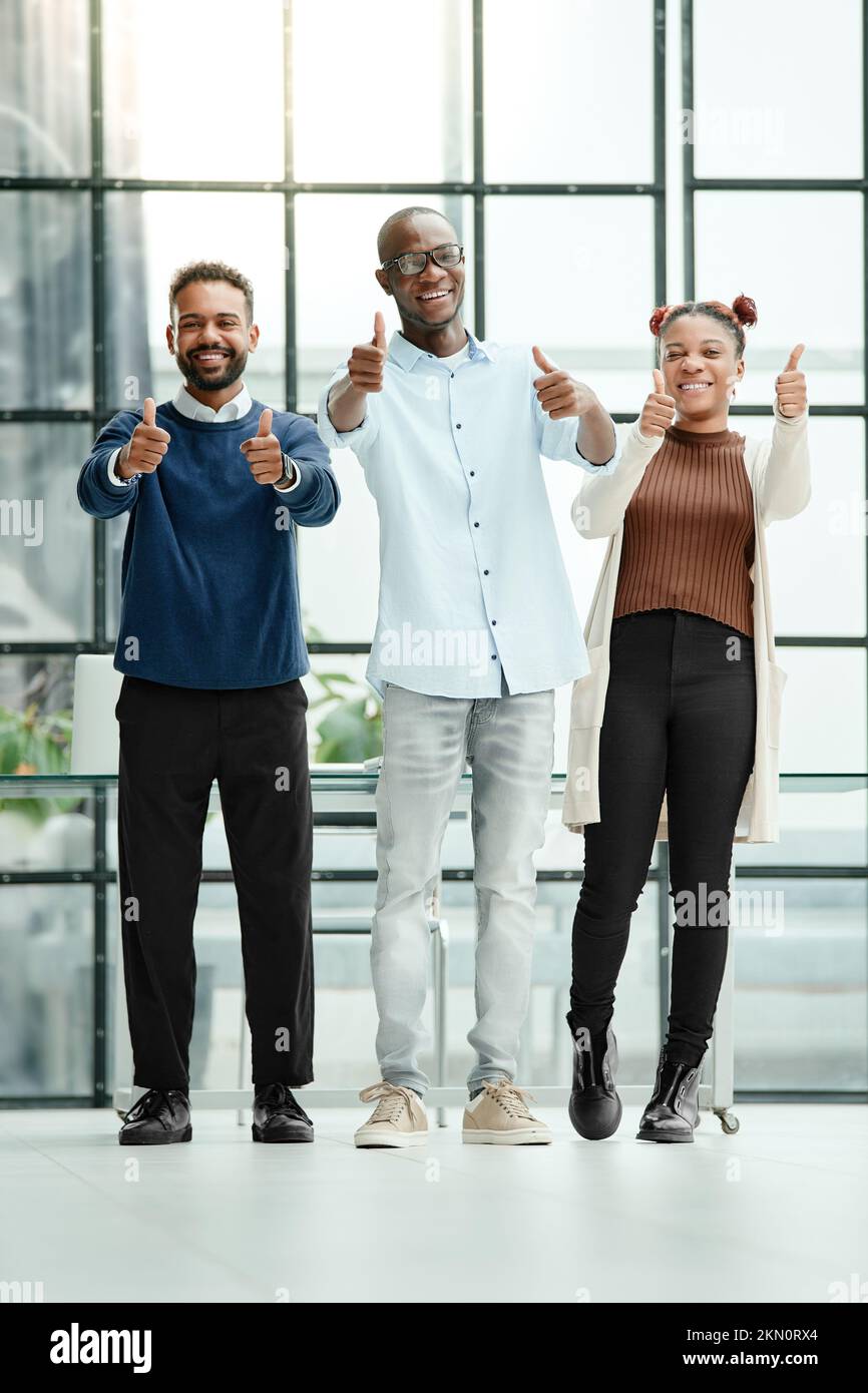 group of young business people showing the thumbs up Stock Photo - Alamy