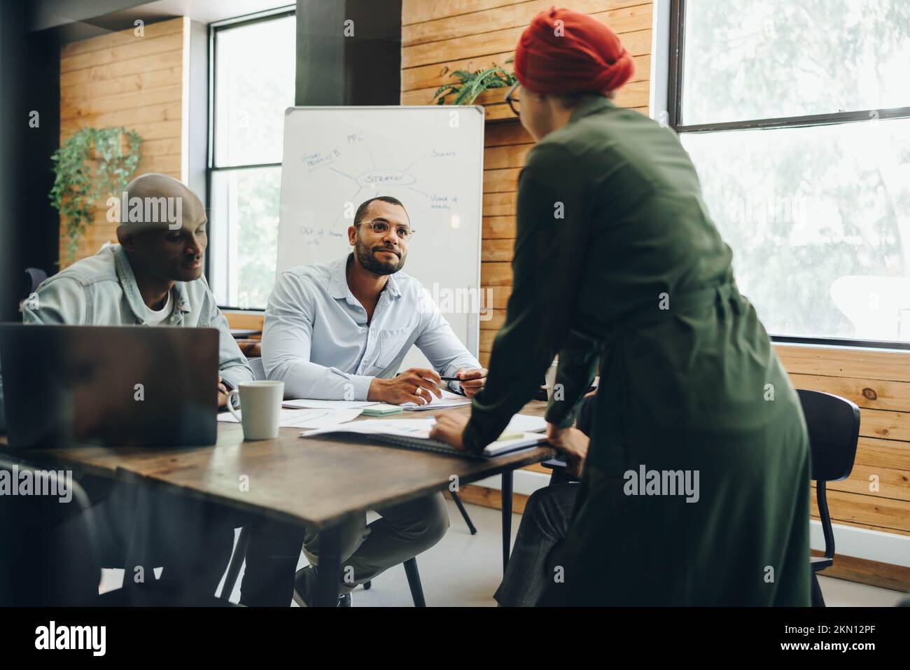Modern businesspeople having a discussion during a meeting in a creative office. Group of multicultural business professionals working as a team in an Stock Photo