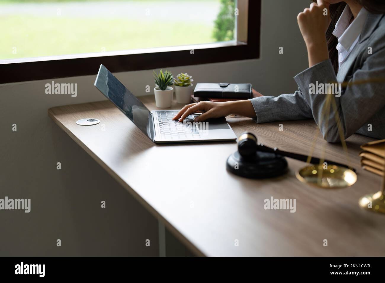 justice and law concept.Male judge in a courtroom on wooden table and Counselor or Closeup lawyer working with lsptop in office. Legal law, advice and Stock Photo