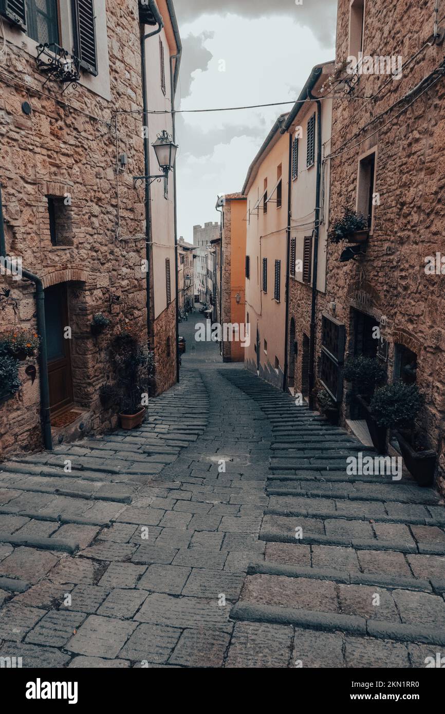 Narrow alley with medieval rock buildings Stock Photo - Alamy