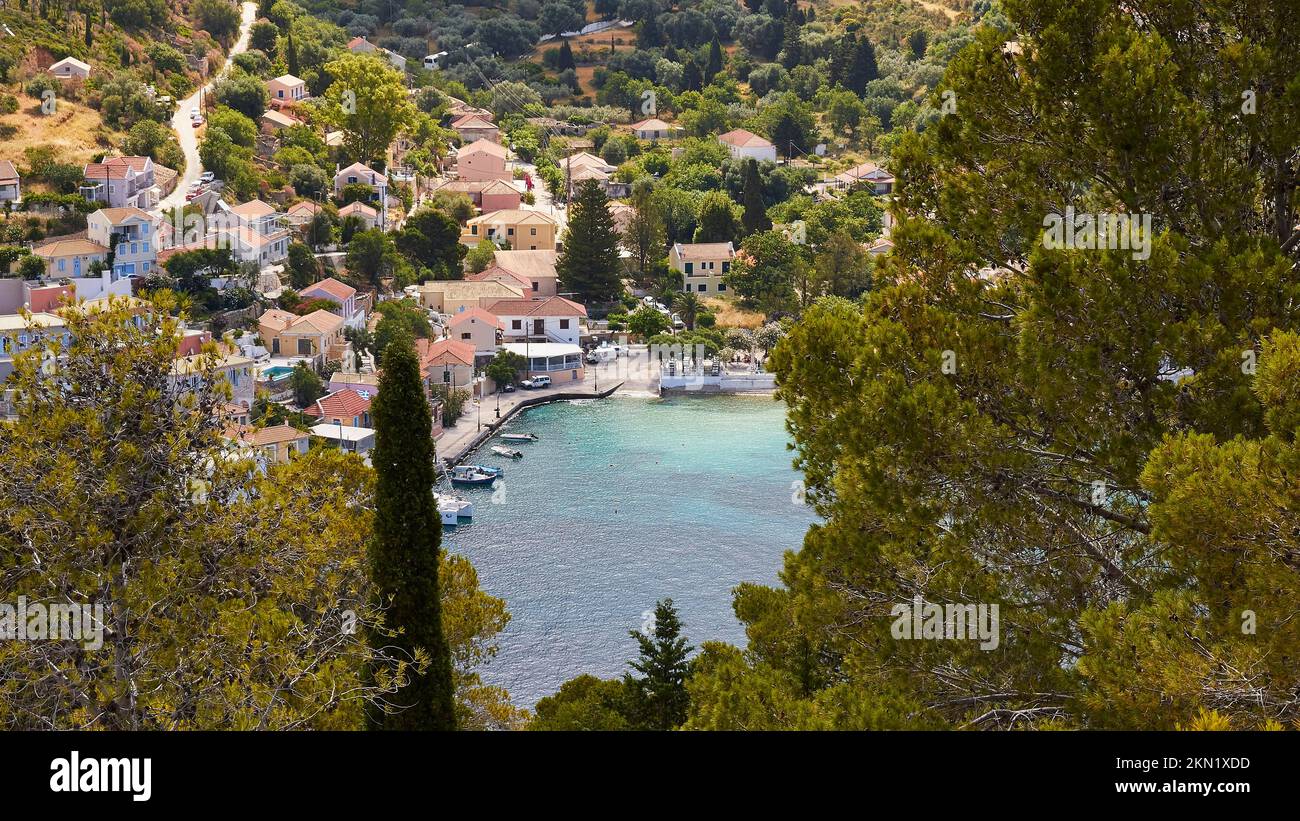 Village, Assos, view through trees, boats, houses, west coast, Kefalonia Island, Ionian Islands, Greece, Europe Stock Photo