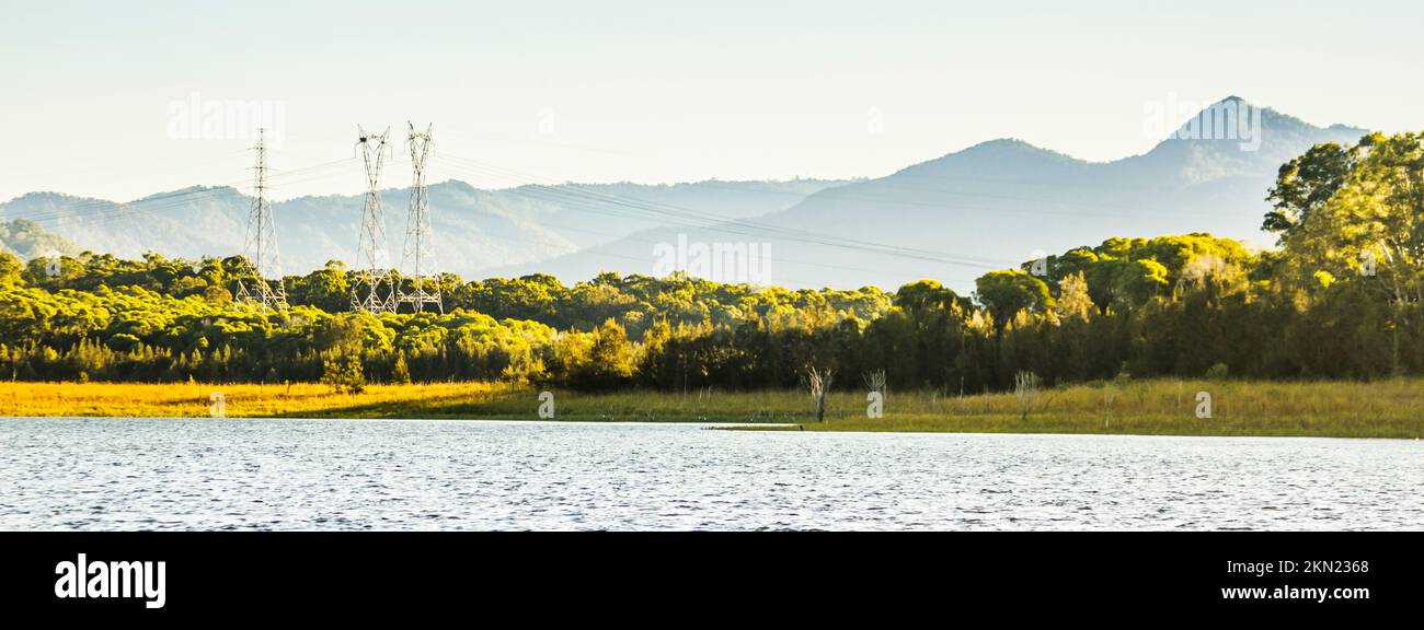 Wide angle landscape art on a riverscape with powerline and mountaintop perspectives. Lake Samsonvale, Petrie, Australia Stock Photo