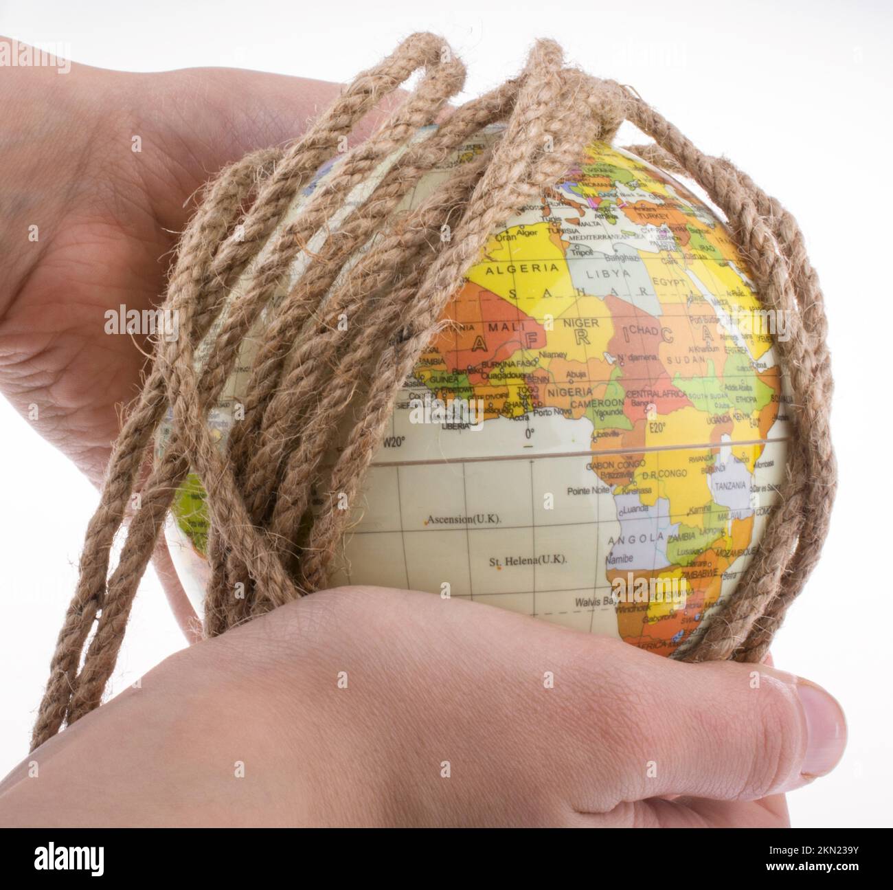 Hands holding the globe wrapped in rope Stock Photo - Alamy