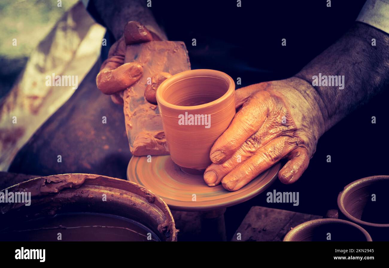 Potter's hands shaping up the clay of the pot Stock Photo Alamy