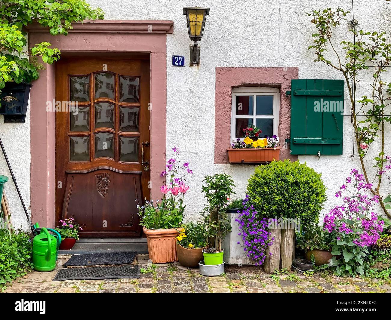 House entrance decorated with flowers and plants in old village Burgdorf Burgbering from 13th century of today destroyed castle Kronenburg, Kronenburg Stock Photo