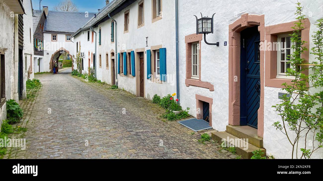 Historic alley with cobblestones in the background Gatehouse archway into old village Burgdorf 13th century Burgbering from today destroyed Kronenburg Stock Photo