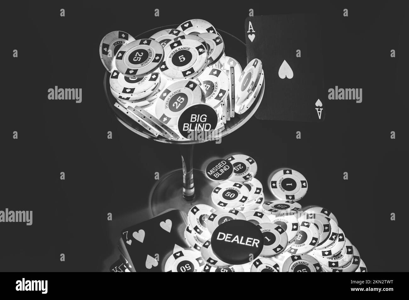 Black and white fine art on a martini glass of poker plays and gaming aces. Casino cocktail Stock Photo