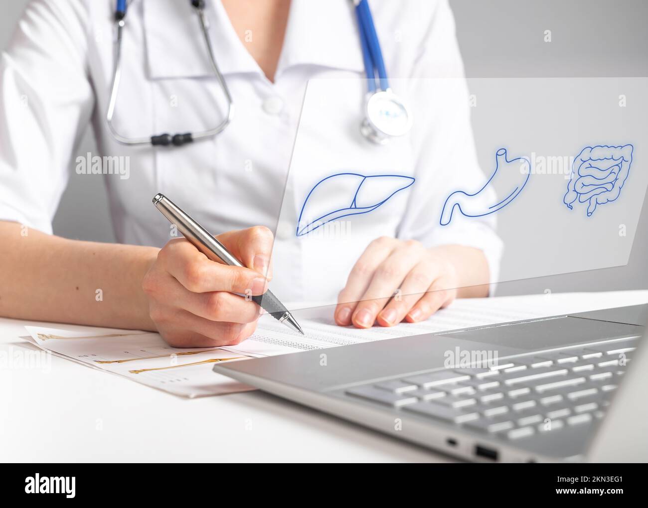 Gastroenterologist doctor works online, sitting at laptop with gastrointestinal results, test, check ups on screen. High quality photo Stock Photo