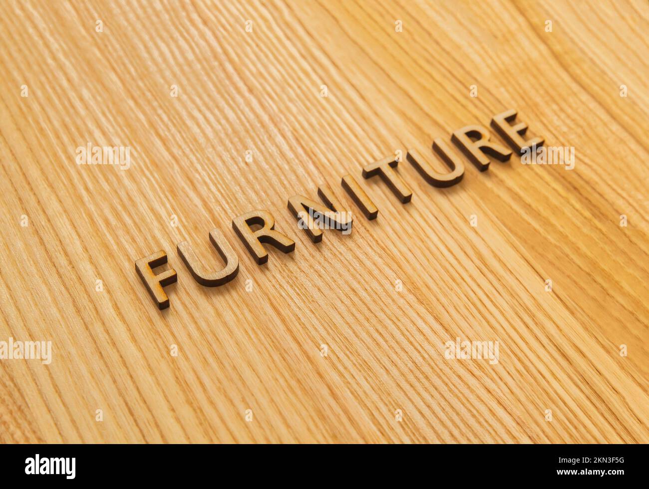 The inscription furniture on the oak table top. Background Stock Photo ...
