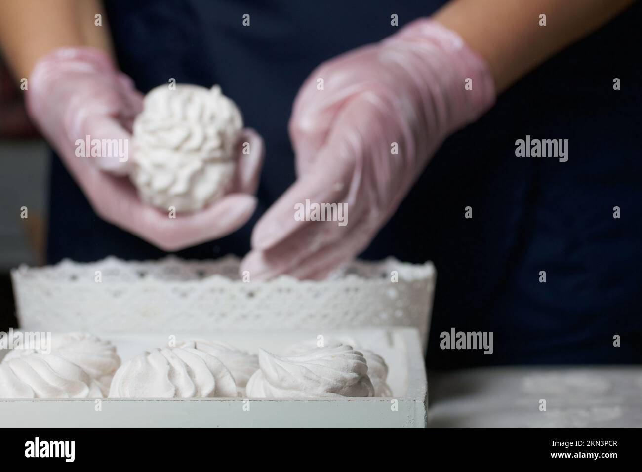 Homemade zephyr. Homemade marshmallows. A woman puts a readymade zephyr on a tray Stock Photo