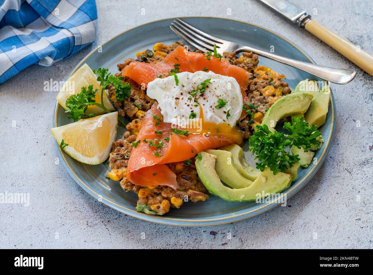 Corn and quinoa fritters with smoked salmon and poached egg Stock Photo