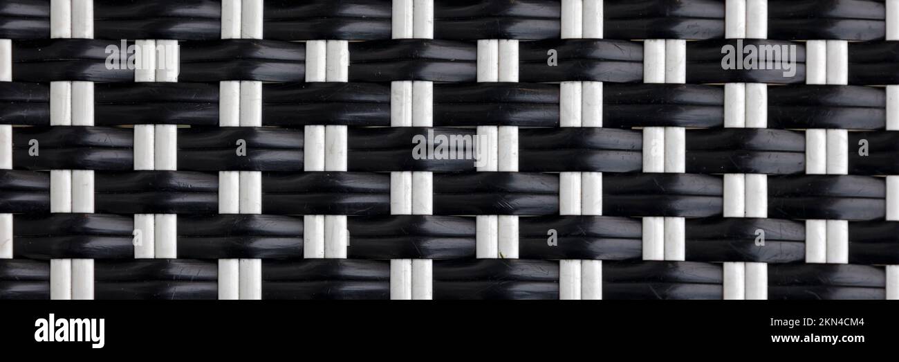 BACKGROUND TEXTURE -  Woven black and white plastic strips in panorama format Stock Photo