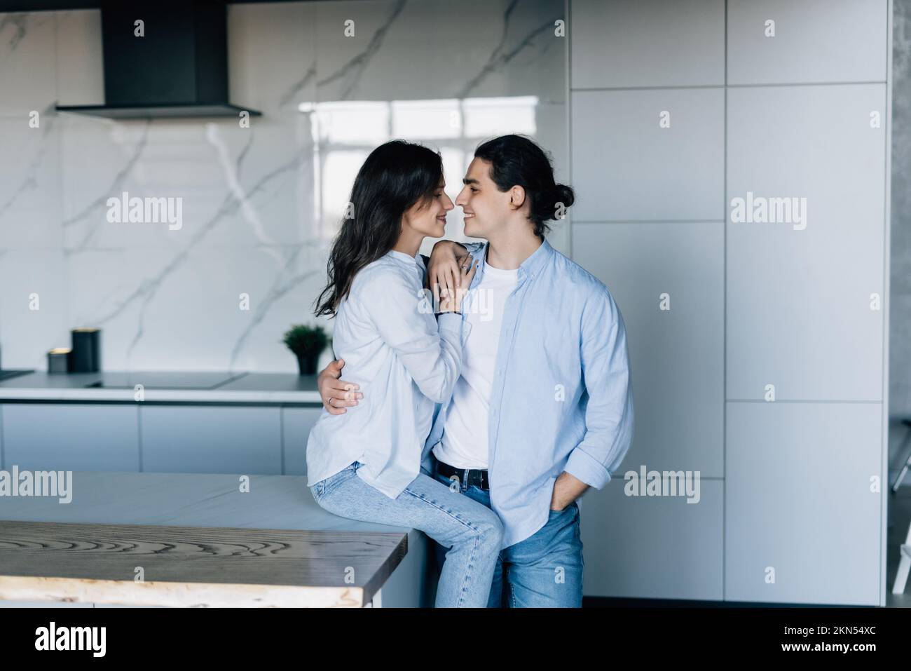 Couple in love hugging and using tablet together. Stock Photo