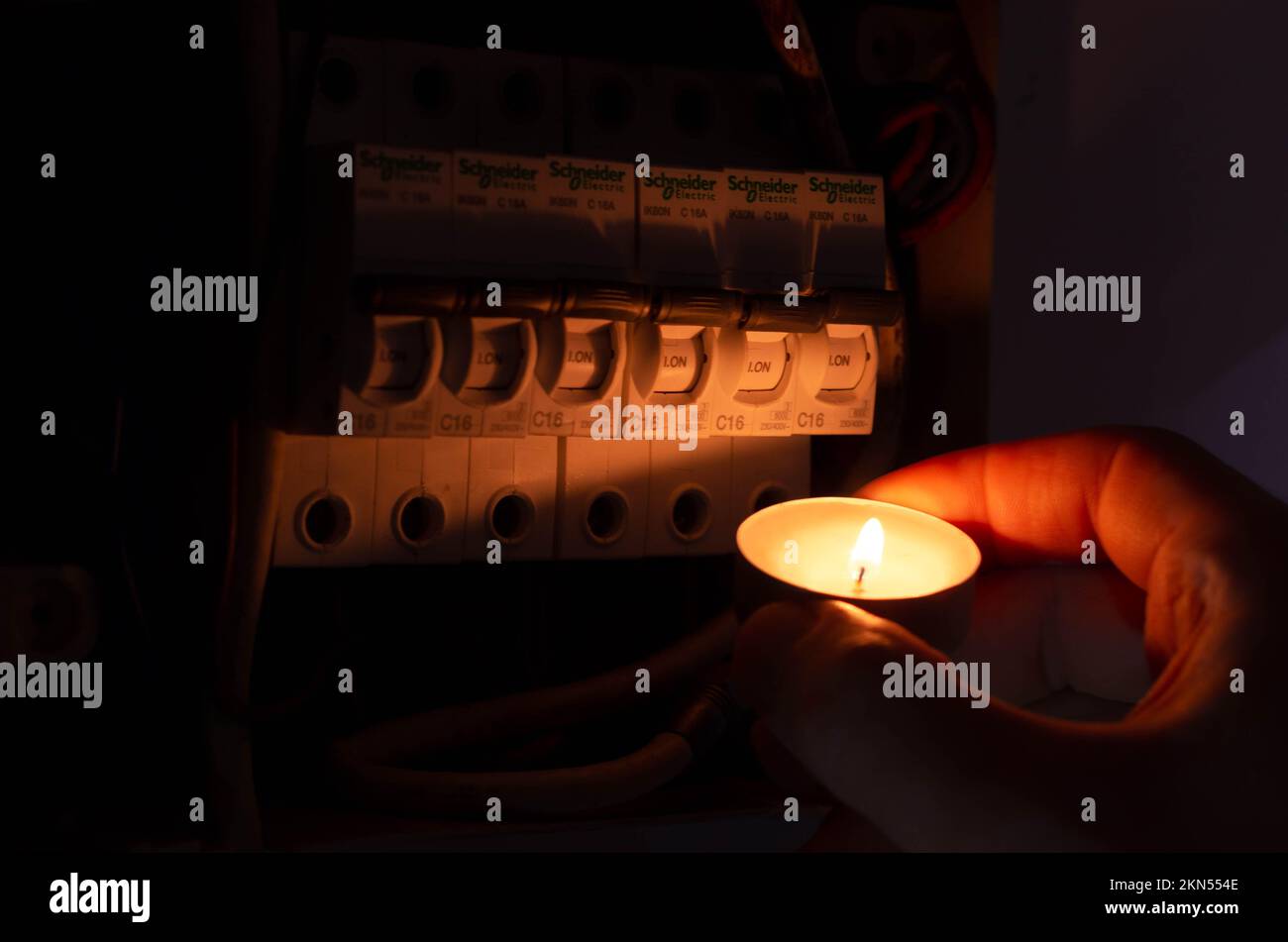 Blackout concept. Person's hand in complete darkness holding a holding