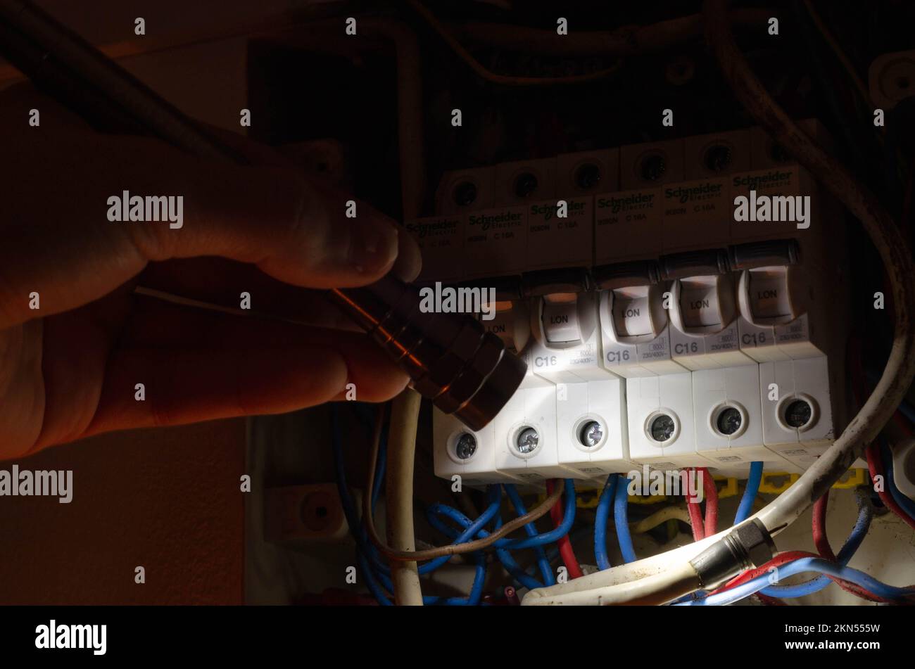 Blackout concept. Person's hand in complete darkness holding a holding