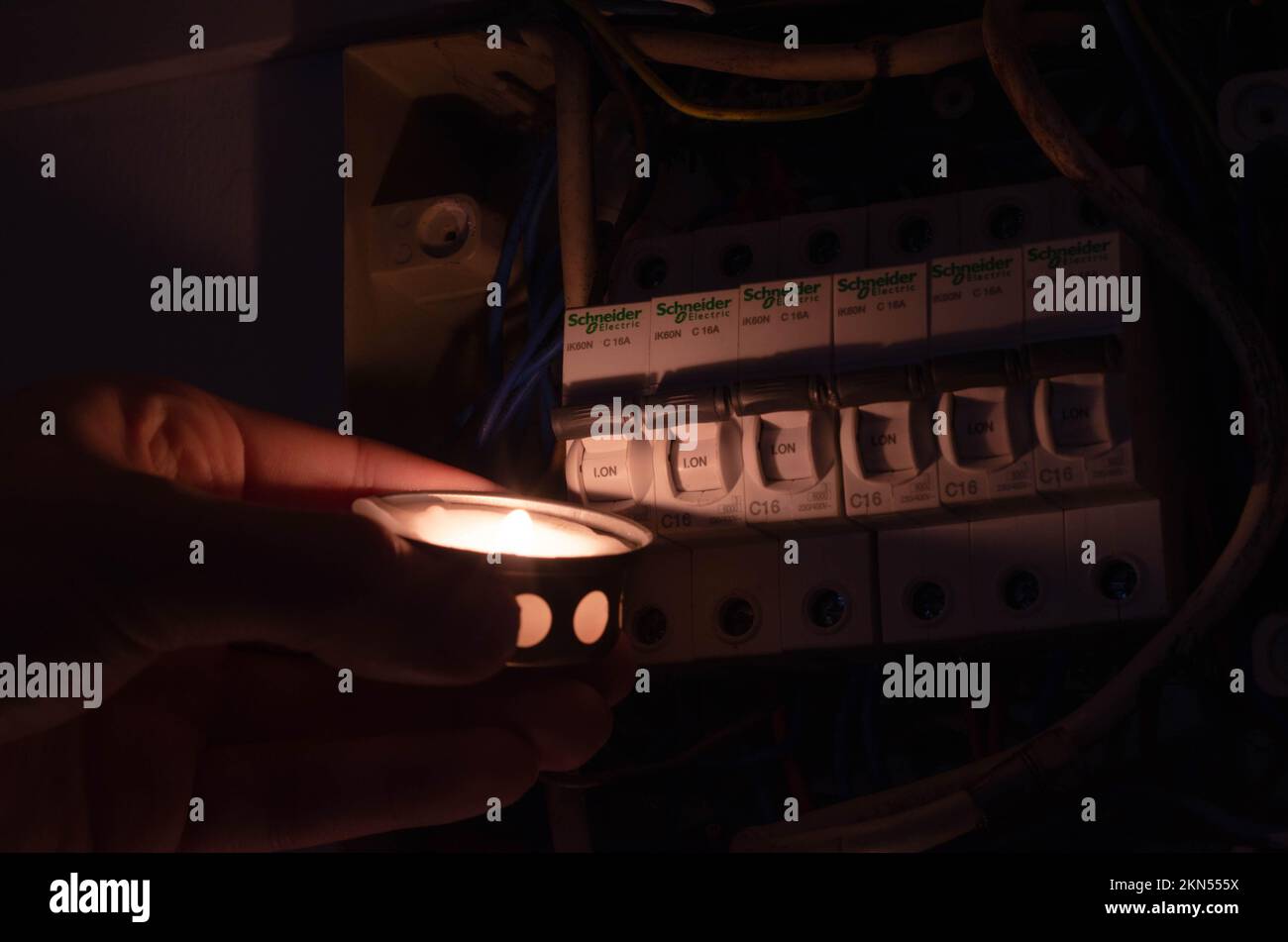 Blackout concept. Person's hand in complete darkness holding a holding