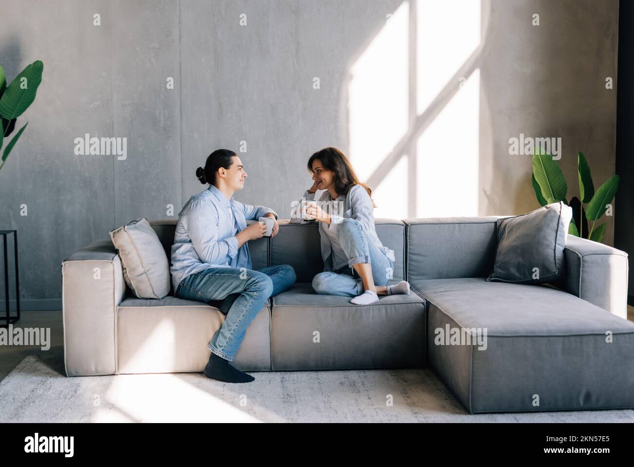 Nothing is better. Affectionate lovers spouses cuddle on couch at