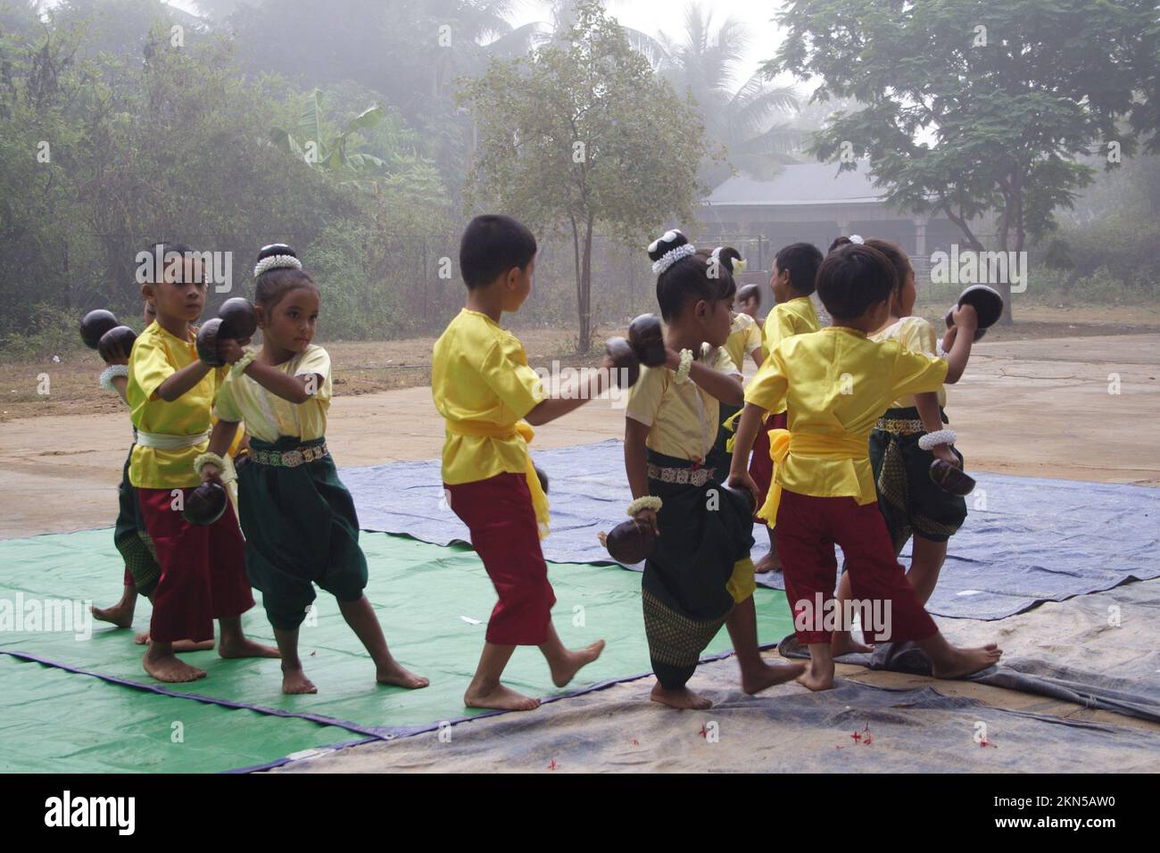 Children doing the coconut shell dance, Vat Luong, Pursat Province, Cambodia. Stock Photo