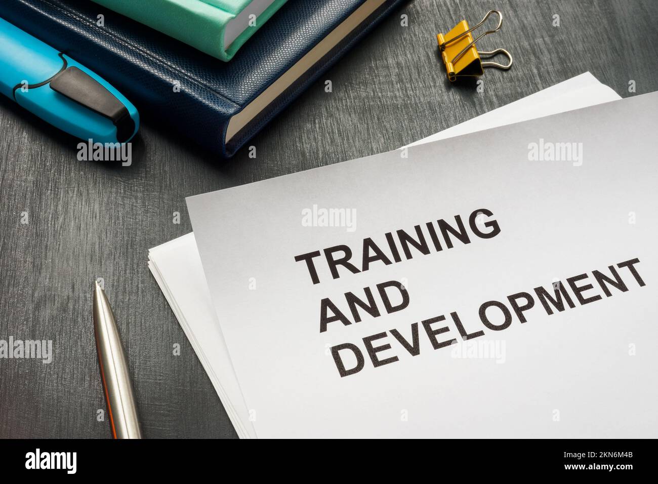 Papers about Training and development on the desk. Stock Photo