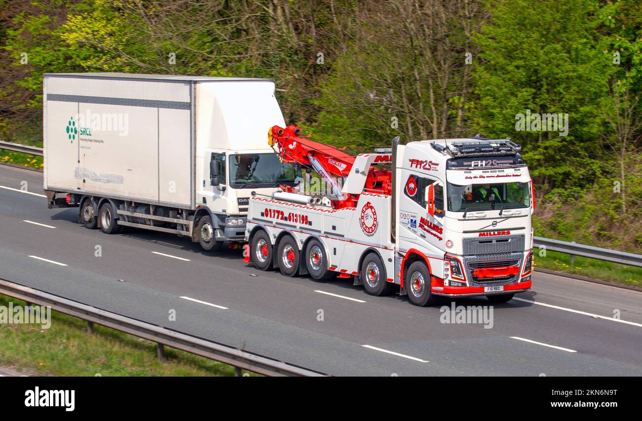 Millers recovery; HGV Haulage breakdown recovery trucks, lorry, transportation, truck, cargo carrier, 2019 Volvo FM vehicle, European commercial transport industry, M6 at Manchester, UK Stock Photo