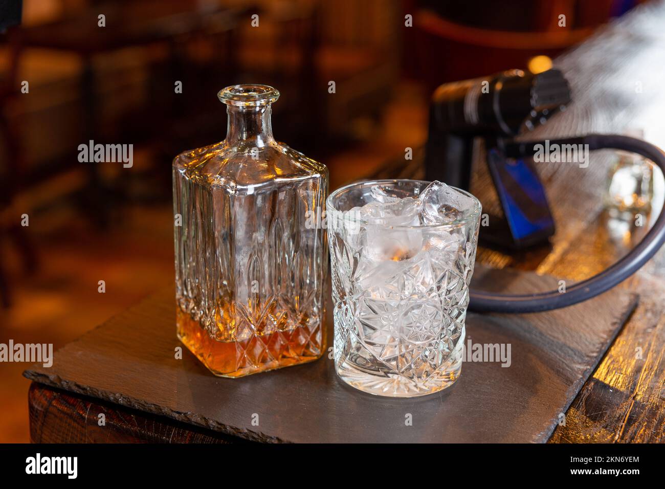 Whisky glass decanter with whisky liquor and an empty glass of whiskey