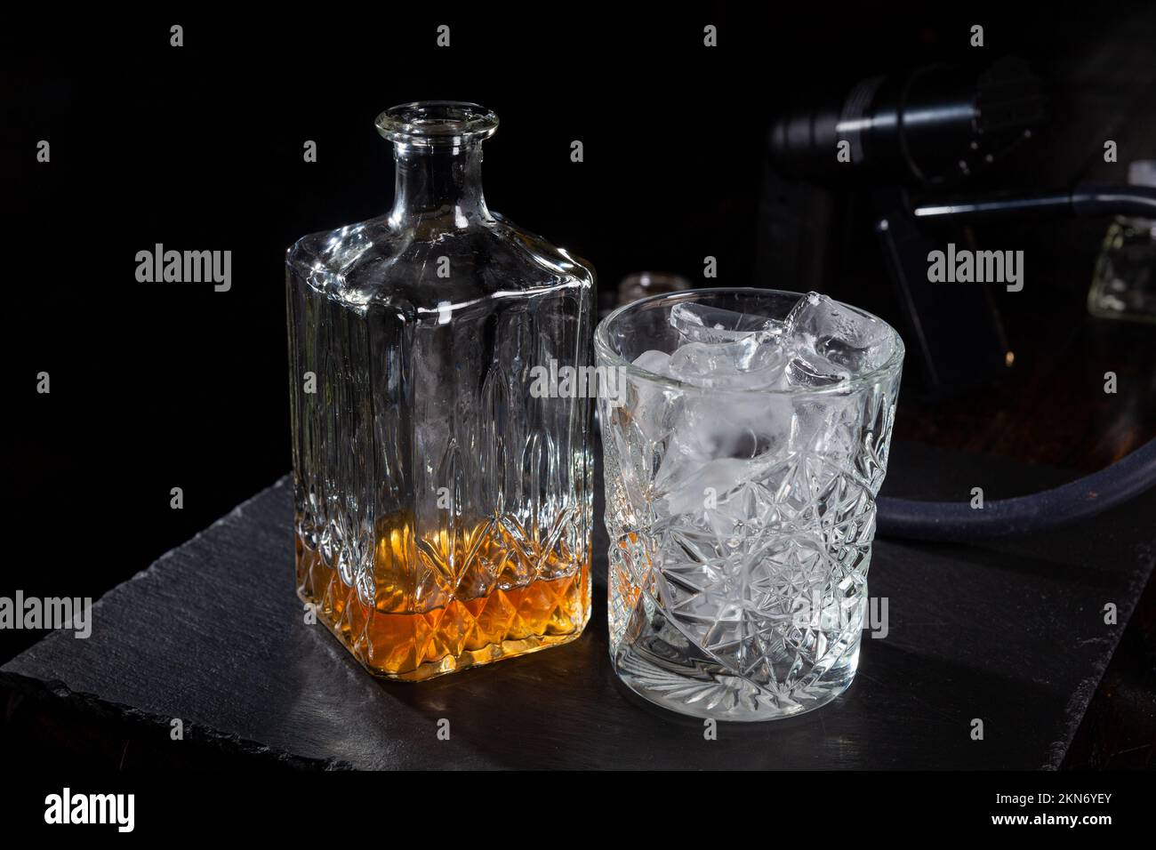 Whisky glass decanter with whisky liquor and an empty glass of whiskey