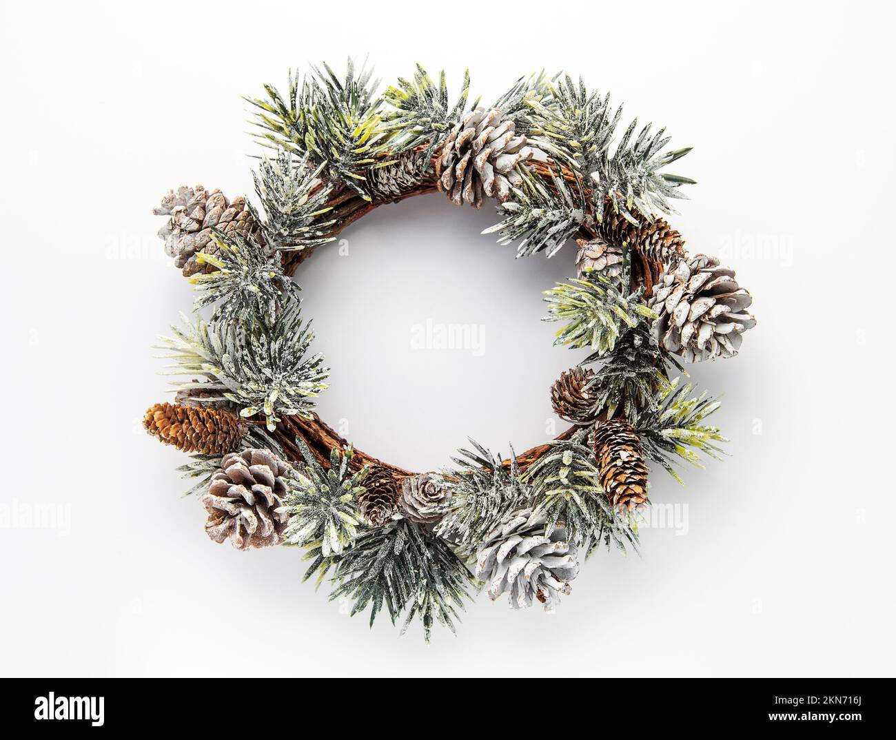 Decorative festive Christmas wreath.  Wreath made of fir tree and cones  on white background.  Christmas decorations Stock Photo