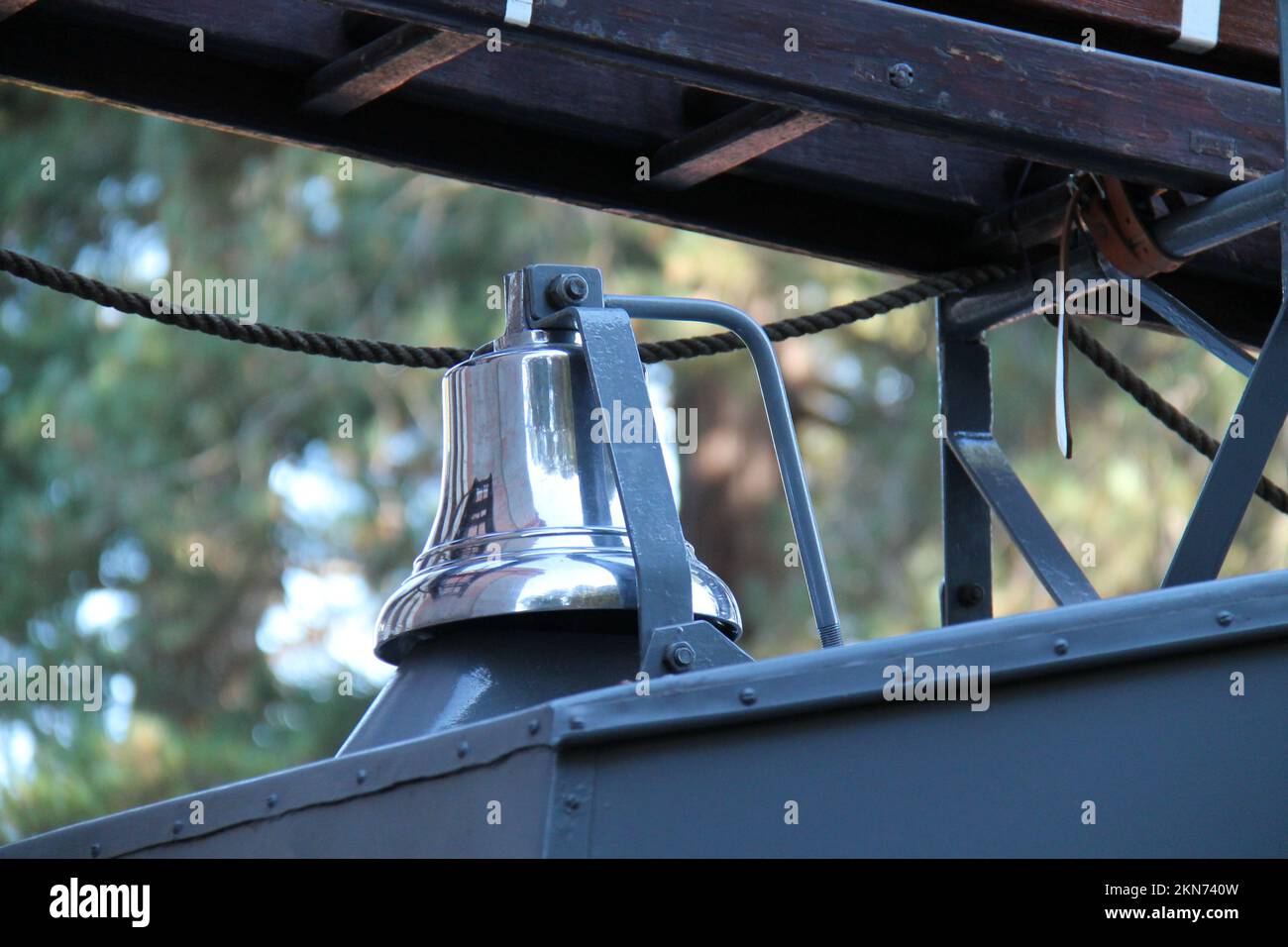 A Silver Warning Bell on a Vintage Fire Engine Vehicle. Stock Photo