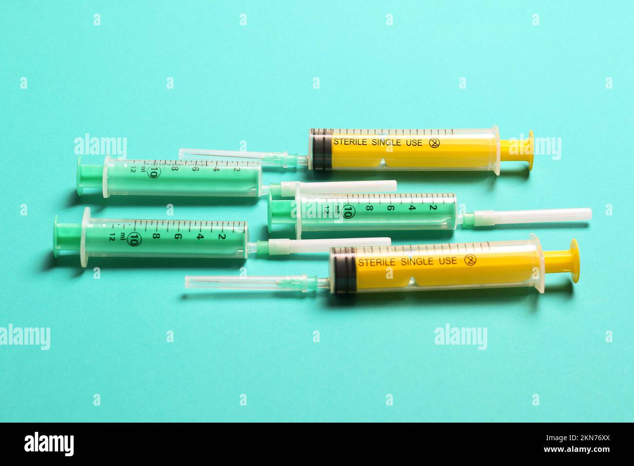 Top view of medical syringes with needles at blue background with copy ...
