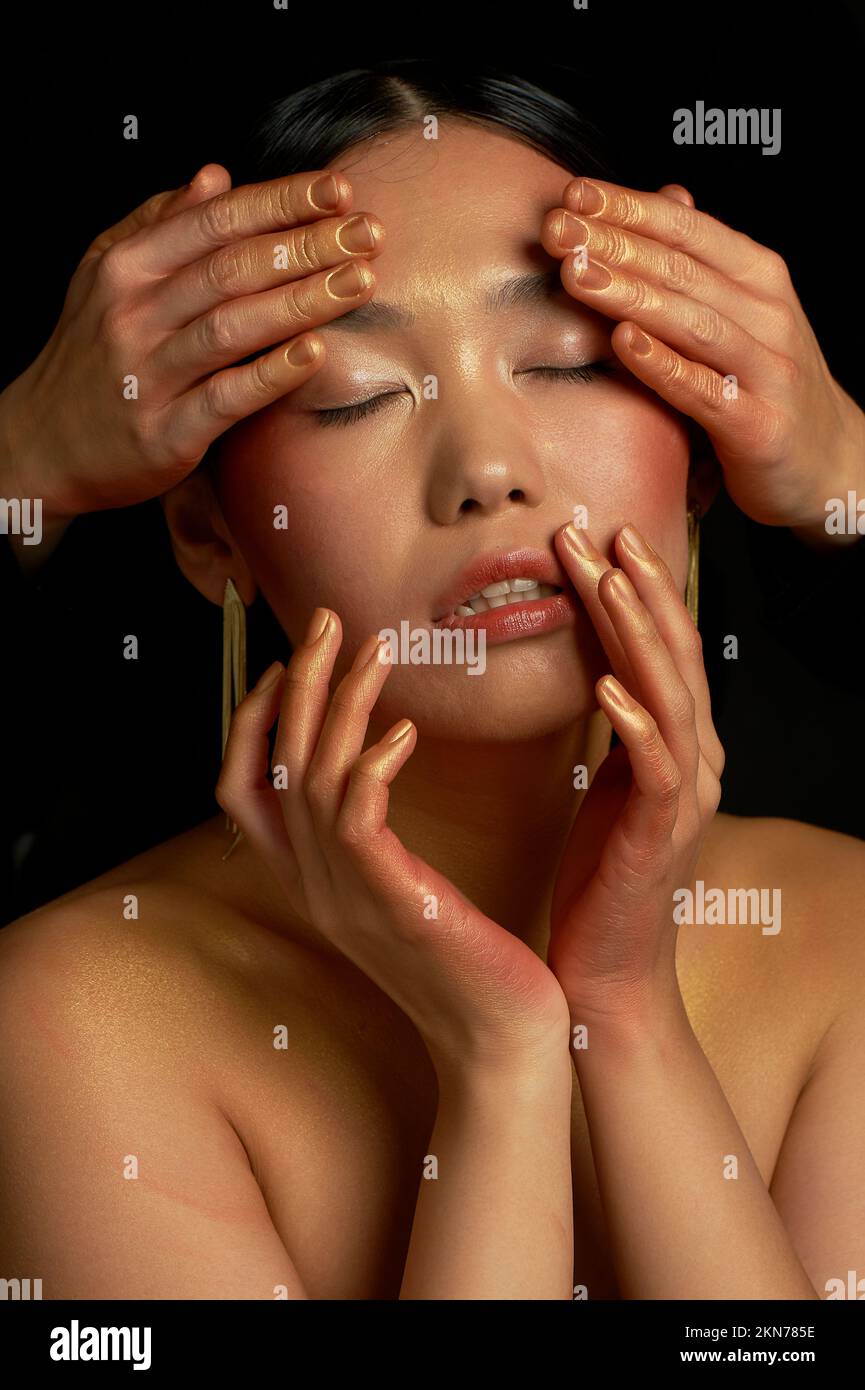 Self-care, facial massage. Relaxation in the beauty salon. Asian girl. Stock Photo