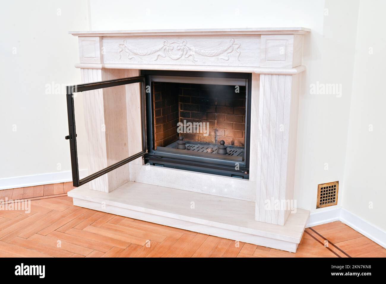 Stylish modern fireplace with a fireproof glass door in a rich house