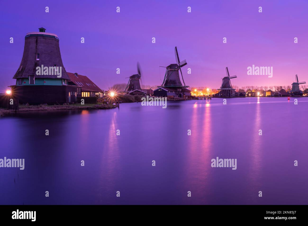 Traditional dutch windmills at Zaanse Schans in the evening Stock Photo