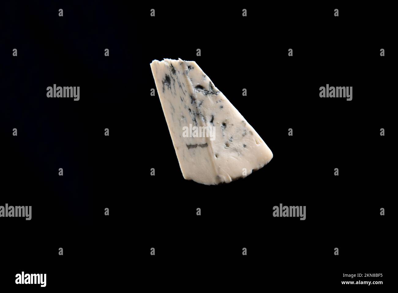 Blue cheese, dor bleu or Roquefort mold cheese on black isolate